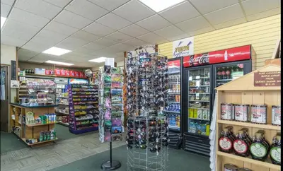 a store aisle with a rack of merchandise in a store at Talbot Arm Motel in Destruction Bay