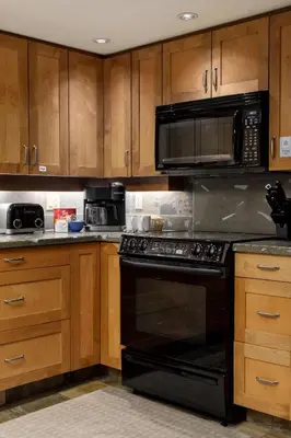 a kitchen with a black oven and a microwave at Spacious 3BR Condo in Whistler in Whistler