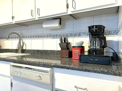 a kitchen counter with a coffee maker on it at Stylish DT Views at Stampede w Free Parking and AC in Calgary