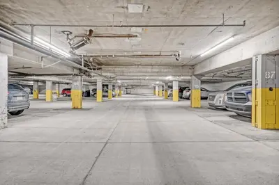 an empty parking garage with cars parked in it at Stylish DT Views at Stampede w Free Parking and AC in Calgary