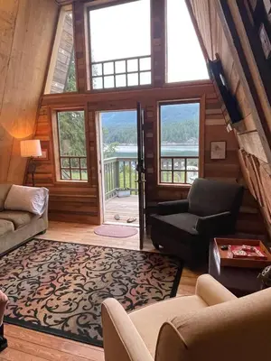 a living room with a large room with windows at Fishermans Folly in Lund