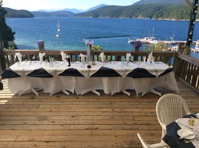 a table on a deck with a view of the water at Fishermans Folly in Lund