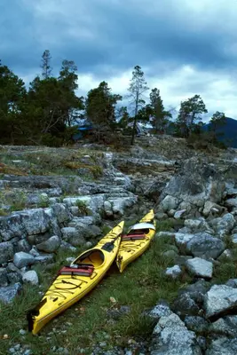 two yellow kayaks sitting on top of a rocky hill at Fishermans Folly in Lund
