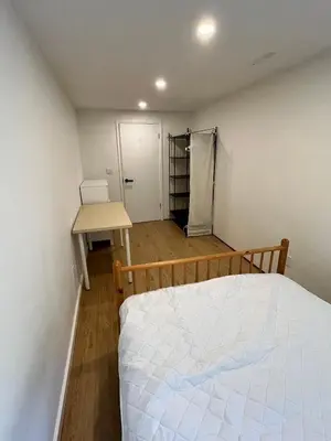 a bedroom with a bed and a table and a desk at Green House in Vancouver West in Vancouver