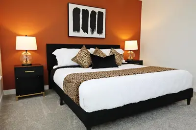 a bedroom with a large bed with two lamps at Elegant Retreat with King Beds,Golf,Disney,Near WEM in Edmonton