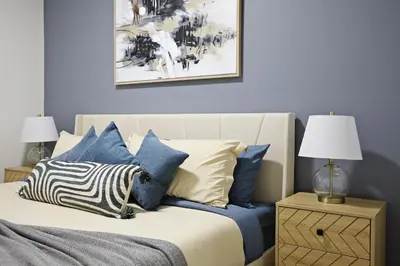 a bedroom with a bed with blue and white pillows at Elegant Escape with King Bed, Long Stays, WEM, Disney in Edmonton