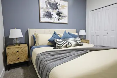 a bedroom with a bed with pillows on it at Elegant Escape with King Bed, Long Stays, WEM, Disney in Edmonton