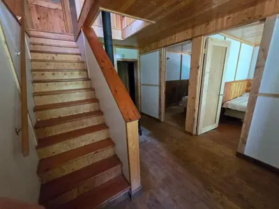 a wooden staircase in a house with wooden floors at Rustic Executive Cabin at Beaverfoot in Parson