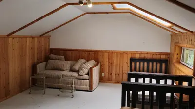 a living room with a couch and a table at Rustic Executive Cabin at Beaverfoot in Parson
