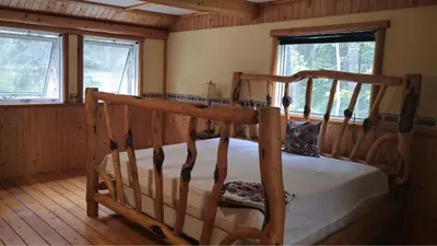 a bedroom with a bunk bed in a cabin at Rustic Executive Cabin at Beaverfoot in Parson