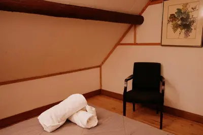 a room with a towel on the floor and a chair at Rustic Basic Cabin at Beaverfoot in Parson