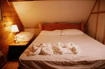 a bedroom with a bed with towels on it at Rustic Basic Cabin at Beaverfoot in Parson