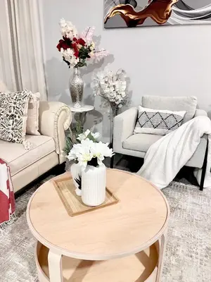 a living room with a table with flowers on it at Spacious & Comfy Upper Floor 3BR Suite in Detached House in Calgary