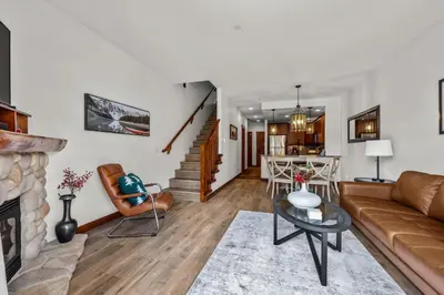 a living room with a couch and a fireplace at Trappers Landing #30 townhouse in Sun Peaks