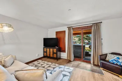 a living room with a couch and a television at Trappers Landing #30 townhouse in Sun Peaks