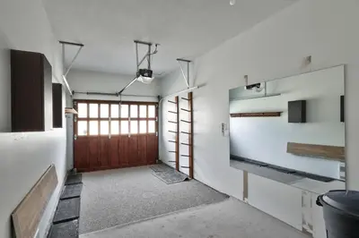 an empty room with a door and a television at Trappers Landing #30 townhouse in Sun Peaks