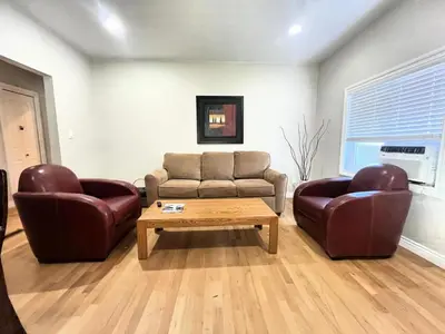 a living room with two chairs and a couch and a coffee table at James house J&J Chilliwack in Chilliwack