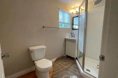 a bathroom with a toilet and a shower and a sink at James house J&J Chilliwack in Chilliwack