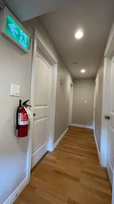 a hallway with a fire hydrant on the wall at James house J&J Chilliwack in Chilliwack