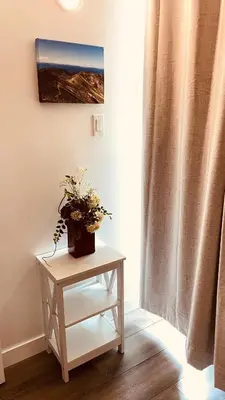 a table with a plant on it next to a window at #202 Cozy Mountain View 2 bedrooms in DT in Canmore