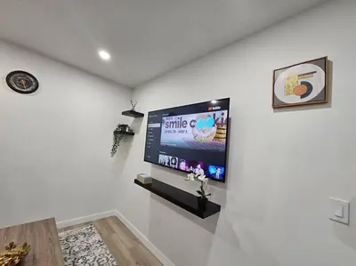 a living room with a flat screen tv on a wall at Parkside Basement Suite in Edmonton