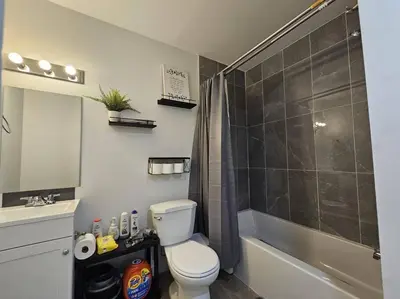a bathroom with a toilet and a shower and a sink at Parkside Basement Suite in Edmonton