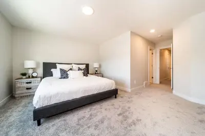 a white bedroom with a large bed in it at Beautiful Elegant Home Sleeps 10, Free Parking, Central AC in Edmonton