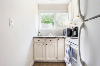 a kitchen with a white refrigerator and a sink at Quiet Area Near Downtown Walkable To Cafes in Maple Ridge District Municipality