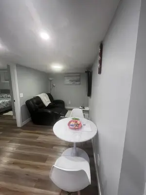 a living room with a table and a couch at Adorable Private Suite in Seton SE, Calgary in Calgary