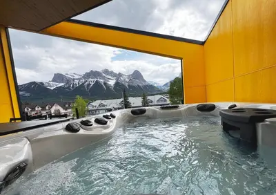 a large bath tub with a view of a mountain at Raven's Peak 105 - Ultra luxe Mountain Retreat in Canmore