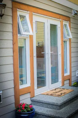 a front door of a house with two windows at Windslow Guest Suite at Kye Bay in Comox