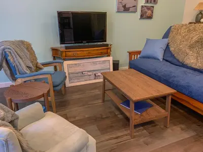a living room with a couch and a tv at Windslow Guest Suite at Kye Bay in Comox