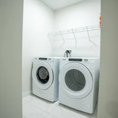 a white washer and dryer in a white room at Warm getaway Perfect for 4 in Edmonton