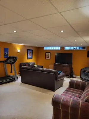 a living room with a couch and a flat screen tv at My Home in Calgary