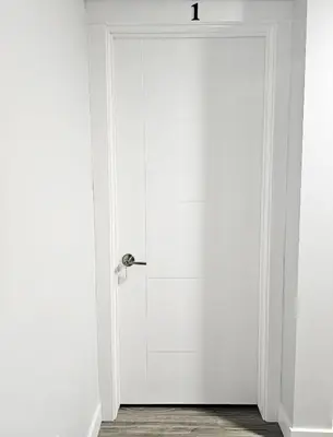 a white door with a silver handle in a room at Guest Suite in Southeast Calgary in Calgary