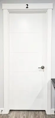 a white door in a room with the number two at Guest Suite in Southeast Calgary in Calgary