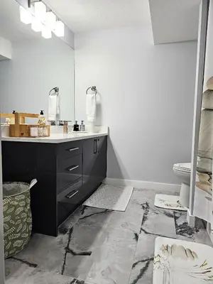 a bathroom with a sink and a toilet at Guest Suite in Southeast Calgary in Calgary