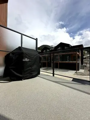 a black bag sitting on the side of a building at Private Hot Tub Ski In Ski Out Sleeps 9 in Panorama