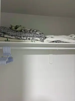 a shelf with blankets and other items on it at Guest Suite in SouthWest Edmonton in Edmonton