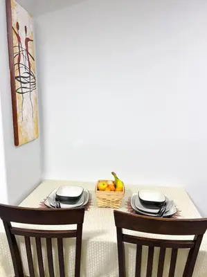 a table with two chairs and a basket of fruit at Guest Suite in SouthWest Edmonton in Edmonton