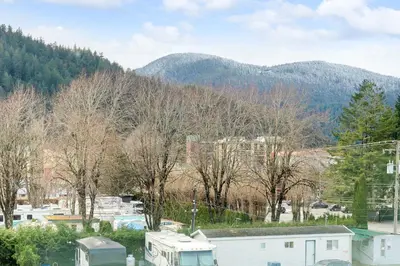 a town with trees and mountains in the background at 306 old in Harrison Hot Springs