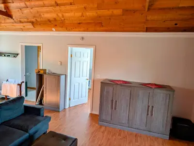 a living room with a couch and a wooden ceiling at Cliff Haven on the Bay in Alert Bay