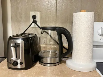 a coffee maker and a toaster and a roll of paper towels at Near Skytrain Metrotown Private Entry 3min walk to grocery food in Burnaby