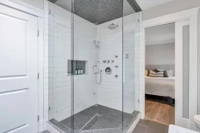 a shower with a glass door in a bathroom at Cozy home in Brookswood in Langley