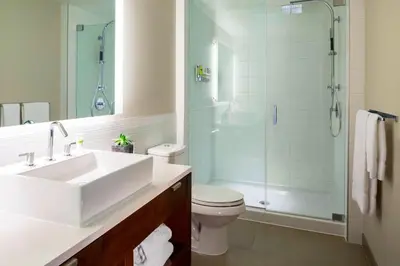 a bathroom with a sink and a shower and a toilet at Element by Westin Vancouver Metrotown in Burnaby