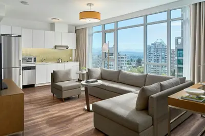 a living room with a couch and a kitchen at Element by Westin Vancouver Metrotown in Burnaby