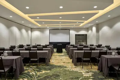 a conference room with tables and chairs and a screen at Element by Westin Vancouver Metrotown in Burnaby