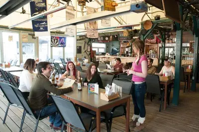 a group of people sitting at tables in a restaurant at Coast High Country Inn in Whitehorse