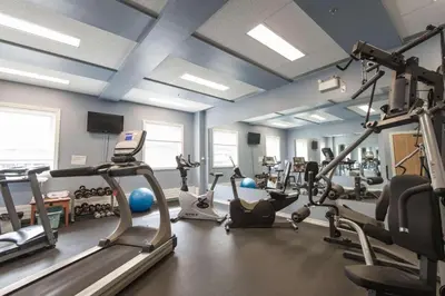 a gym with several treadmills and exercise bikes at Coast High Country Inn in Whitehorse