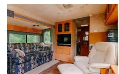 a train room with a couch and chairs and a television at Lower Meadow on Saltspring Island in Fernwood